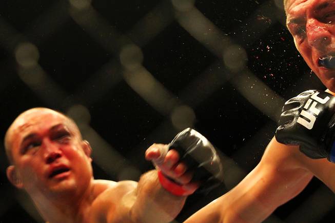 B.J. Penn hits Nick Diaz with a left during their bout at UFC 137 on Saturday, Oct. 29, 2011, at the Mandalay Bay Events Center. Diaz won by unanimous decision, and Penn announced his retirement after the fight.