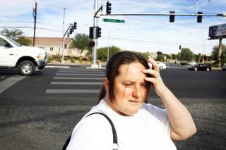 Latacsha Paniza waits to cross Tropicana Avenue at Boulder Highway in Las Vegas Thursday, November 3, 2011.