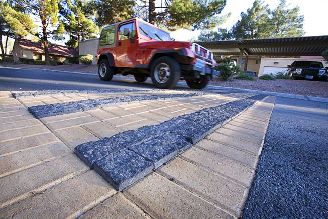 A resident drives over recently installed rumble strips in Quail Estates West community off Valley View Boulevard near Sahara Avenue Monday, October 7, 2011. The strips can be placed as a warning before a cross walk or in a congested area to remind people to watch their speed. 