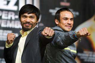 Filipino boxer Manny Pacquiao, left, and Mexican boxer Juan Manuel Marquez pose during a news conference at the MGM Grand Wednesday, November 9, 2011. Pacquiao will face Marquez for the third time when he defends his WBO welterweight title against Marquez at the MGM Grand Garden Arena Saturday. 