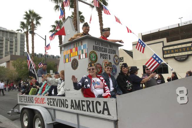 Veterans and members of the Las Vegas American Legion Post 8 waive at the crowd during the Veterans Day parade on 4th Street in downtown Las Vegas on Friday, Nov. 11, 2011.