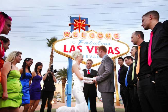 Ashley Hankinson and Jeremy Hankinson of Brantford, Ontario, get married at the Welcome to Fabulous Las Vegas sign on Friday, Nov. 11, 2011.