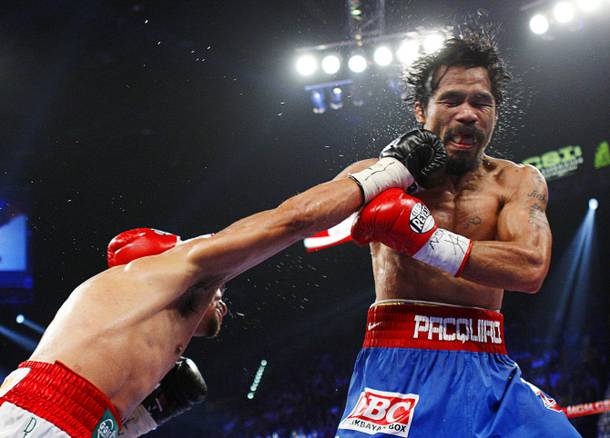 Juan Manuel Marquez, left, of Mexico connects on Manny Pacquiao of the Philippines during their WBO welterweight fight at the MGM Grand Garden Arena Saturday Nov. 12, 2011.