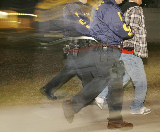 Immigration and Customs Enforcement officers arrest a suspected illegal immigrant in Santa Ana, Calif., in this 2007 file photo. 