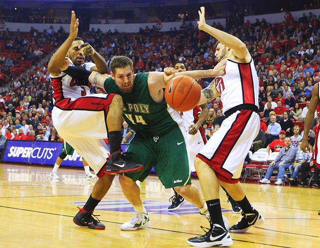 Cal Poly center Will Donahue pushes away UNLV guard Anthony Marshall, left, and forward Carlos Lopez during their game Tuesday, Nov. 22, 2011 at the Thomas & Mack Center.