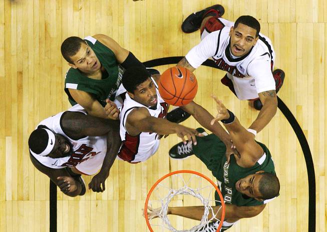 UNLV's Brice Massamba, Justin Hawkins and Anthony Marshall challenge Cal Poly's Chris Eversley, left, and Jordan Lewis for a rebound during their game Tuesday, Nov. 22, 2011 at the Thomas & Mack Center. UNLV won the game 75-52.