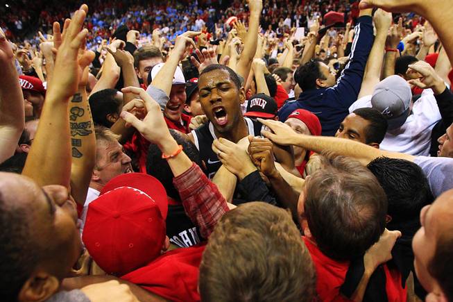 UNLV forward Mike Moser is mobbed by fans after defeating the University of North Carolina during the Las Vegas Invitational championship game Saturday, Nov. 26, 2011 at the Orleans Arena. The Rebels upset the number one ranked Tar Heels 90-80.