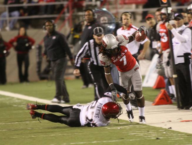 UNLV wide receiver Michael Johnson (7) is pushed out of bounds by San Diego State's player Eric Pinkins during their game Saturday, Nov. 26, 2011.  
