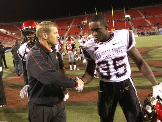 UNLV coach Bobby Hauck shakes the hand of San Diego State's Dwayne Garrett after the Rebels lost to the Aztecs on Senior Night, Saturday, Nov. 26, 2011.