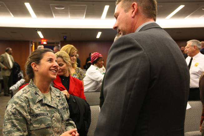 Col. Carol Yannarella, vice commander at Nellis Air Force Base, congratulates North Las Vegas City Manager Timothy Hacker on the new City Hall during the grand opening celebration Thursday evening, Dec. 1, 2011.