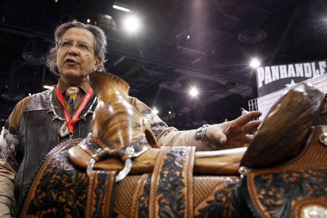 A wooden saddle carved by Andy Sanchez of Algodones, New Mexico for sale for $25,000 at the Cowboy Christmas Gift Show at the Las Vegas Convention Center in Las Vegas Thursday, Dec. 1, 2011.
