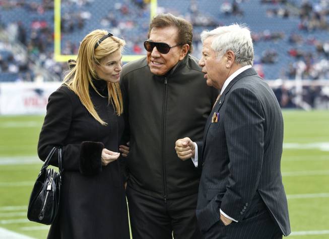 New England Patriots owner Robert Kraft, right, hosts casino mogul Steve Wynn and his wife, Andrea Hissom, on the field at Gillette Stadium prior to the Patriots' NFL football game against the Indianapolis Colts in Foxborough, Mass., Sunday, Dec. 4, 2011.