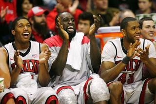 From left, UNLV's Justin Hawkins, Brice Massamba and Mike Moser cheer their teammates on against Cal State San Marcos Wednesday, Dec. 7, 2011, at the Orleans Arena. UNLV won the game, 94-50.