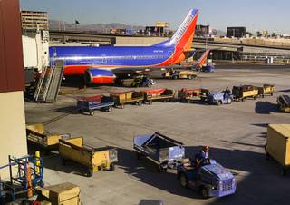 A Southwest Airlines passenger jet is shown at a gate at McCarran International Airport on Dec. 9, 2011.