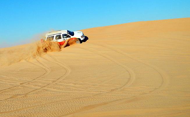 In Dubai, United Arab Emirates, four-wheeling in the sand dunes on the city outskirts. December  2011.