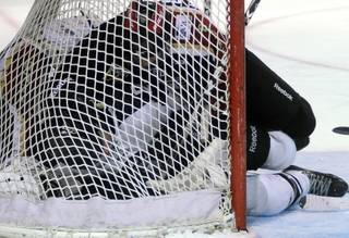 Wranglers forward Josh Lunden finds himself sandwiched between Bakersfield goaltender Bryan Pitton (bottom) and pressing defenseman Tyson Gimblett after a play is blown dead late in the third period as Las Vegas hosted the Condors on Friday night.