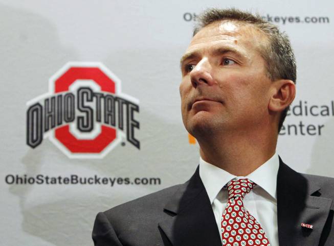 Former Florida coach Urban Meyer appears at a news conference to officially accept the same position at Ohio State.