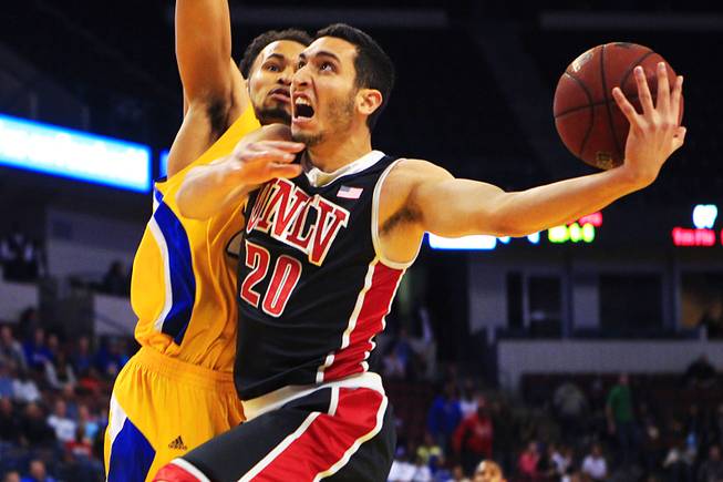 UNLV's Karam Mashour drives past Cal State-Bakersfield forward Adam Young during their game Thursday, Jan. 5, 2012 at Rabobank Arena in Bakersfield. UNLV won their final non-conference game 89-57.