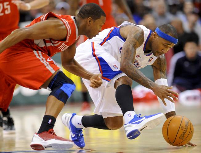 Houston Rockets guard Kyle Lowry, left, and Los Angeles Clippers guard Mo Williams, right, scramble for a loose ball in the first half of a NBA basketball game, Wednesday, Jan. 4, 2012, in Los Angeles.