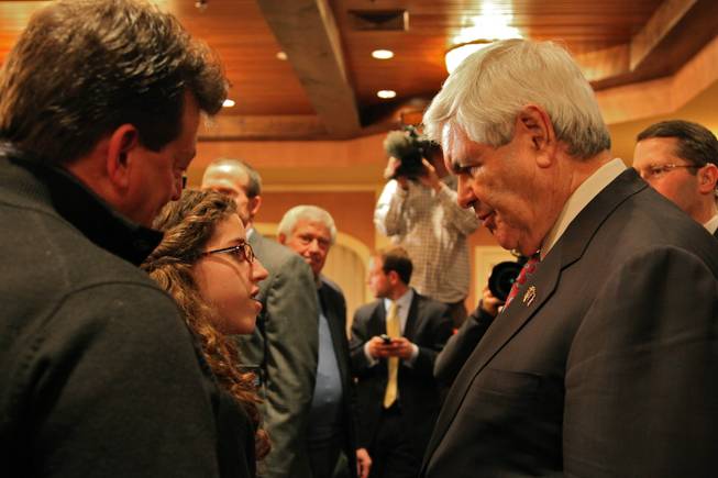 Republican presidential candidate Newt Gingrich speaks to the youngest member of the audience that attended his town hall at the Inn at Mill Falls in Meredith, N.H. Thursday night.