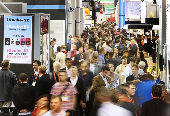 Showgoers navigate an aisle on the tradeshow floor during the 2012 International Consumer Electronics Show (CES) in Las Vegas, Nevada, Jan. 11, 2012. CES, the world's largest consumer technology tradeshow, runs through Friday.