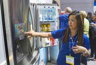 Samsung's Krystle Richcreek demonstrates a prototype Internet-enabled refrigerator with a 10.2 inch screen during the 2012 International Consumer Electronics Show (CES) in Las Vegas, Nevada, Jan. 12, 2012. The refrigerator, which connects to the Internet via Wi-Fi, has a variety of Apps including a grocery inventory manager and a Twitter feed. CES, the world's largest consumer technology tradeshow, runs through Friday.