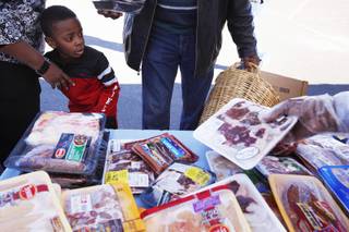 Ezreal Williams, 5, of Las Vegas accompanies his grandparents at a mobile food bank organized by Family Youth Enrichment at Grace Immanuel Baptist Church in Las Vegas on Friday, Jan. 13, 2012.