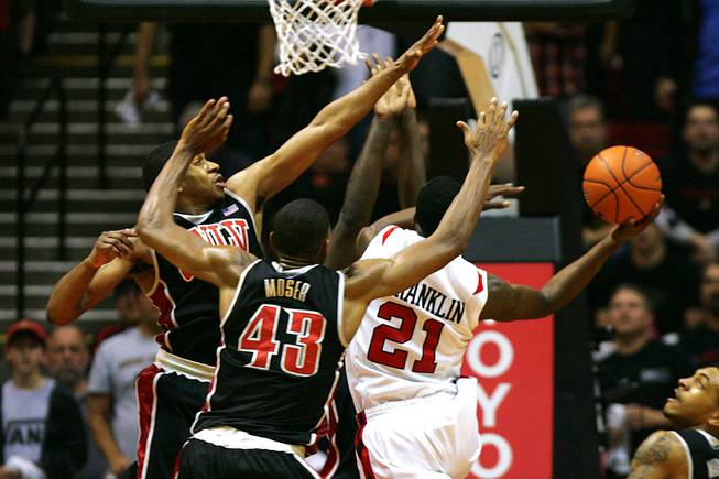 UNLV's Oscar Bellfield, left, Mike Moser and Brice Massamba (not seen) guard San Diego State guard Jamaal Franklin as he takes a last second shot to win the game Saturday, Jan. 14, 2012 at Viejas Arena in San Diego. San Diego State won the Mountain West Conference opener 69-67.
