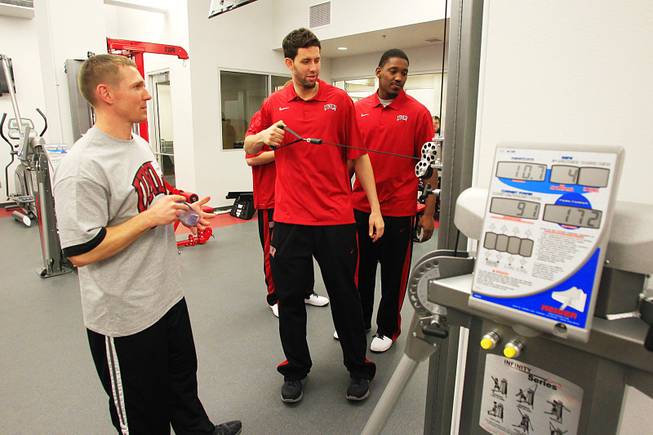 Strength and conditioning coach Jason Kabo watches as Carlos Lopez tries out a piece of equipment in the Joel Anthony weight room during the grand opening of UNLV's new basketball practice facility, the $11.7 million Mendenhall Center, Thursday, Jan. 19, 2012.
