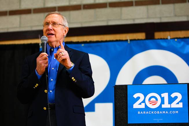 Sen. Harry Reid encourages support for President Obama while speaking at the 2012 Democratic Caucus Saturday, Jan. 21, 2012, at Cheyenne High School.