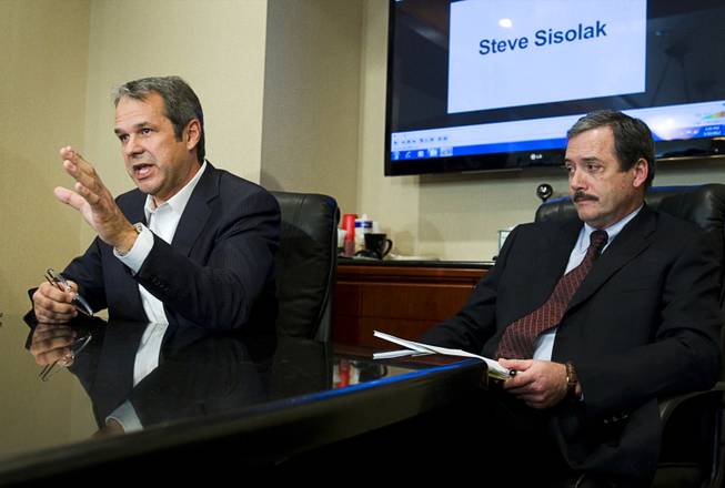 Mark Fierro, left, a public relations expert, and Robert Martin, attorney for former Henderson City Councilwoman Kathleen Vermillion, respond to questions during a news conference at the Martin & Allison law offices Monday, Jan. 23, 2012. The pair disputed allegations by Clark County Commissioner Steve Sisolak that Vermillion, Sisolak's former girlfriend, Fierro and Martin were involved in an an extortion attempt.