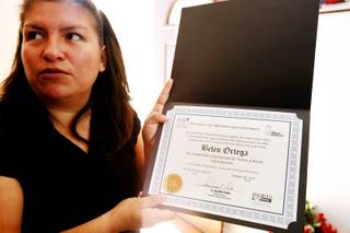 Belem Ortega holds up a certificate she got from CCSD inside her Las Vegas home on Jan. 24, 2012.