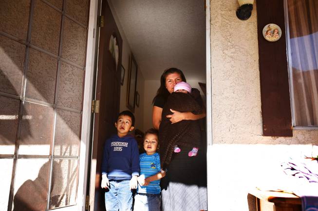 Belem Ortega inside her home with her children Roberto, 4, Aldo, 2, and Maria Belem, 7 months, in Las Vegas on Jan. 24, 2012.