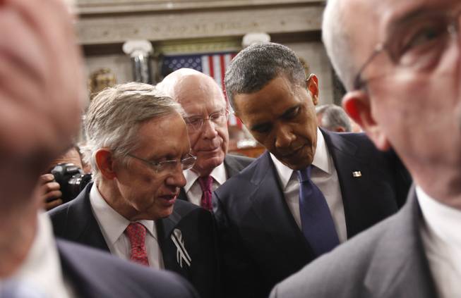 President Barack Obama talks with Senate Majority Leader Harry Reid of Nevada, left, and Sen. Patrick Leahy, D-Vt., on Capitol Hill in Washington on Tuesday, Jan. 25, 2011, after delivering his State of the Union address. 