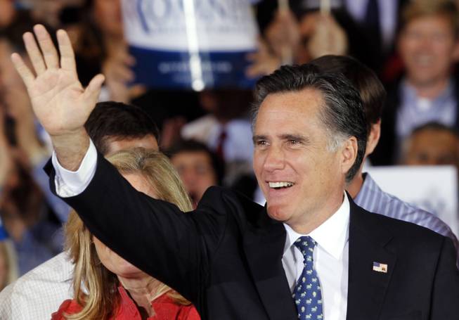 Republican presidential candidate Mitt Romney waves to supporters during his victory celebration after winning the Florida primary election Tuesday, Jan. 31, 2012, in Tampa, Fla.