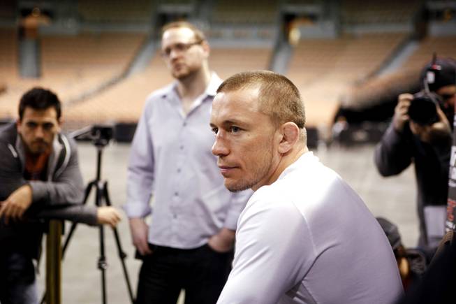 Georges St. Pierre talks with the media during open workouts for UFC 143 at Mandalay Bay Events Center in Las Vegas on Wednesday, Feb. 1, 2012.