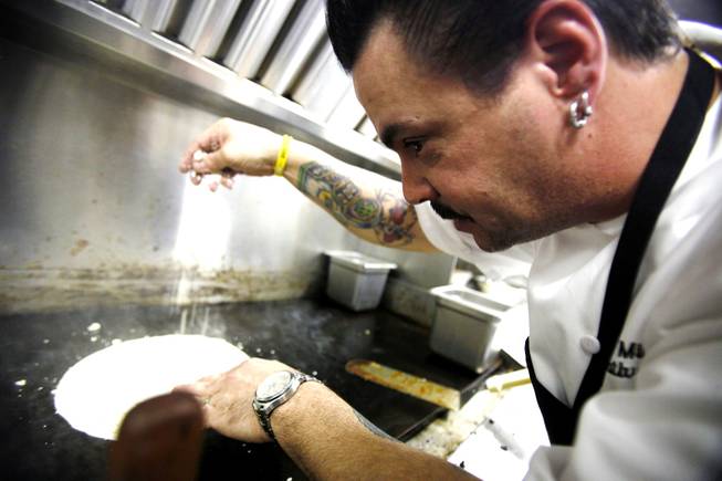 Executive chef Mike Minor cooks inside the Border Grill truck at the South Point Gourmet Food Truck Fest in the parking lot of the South Point in Las Vegas Wednesday, Feb. 1, 2012.