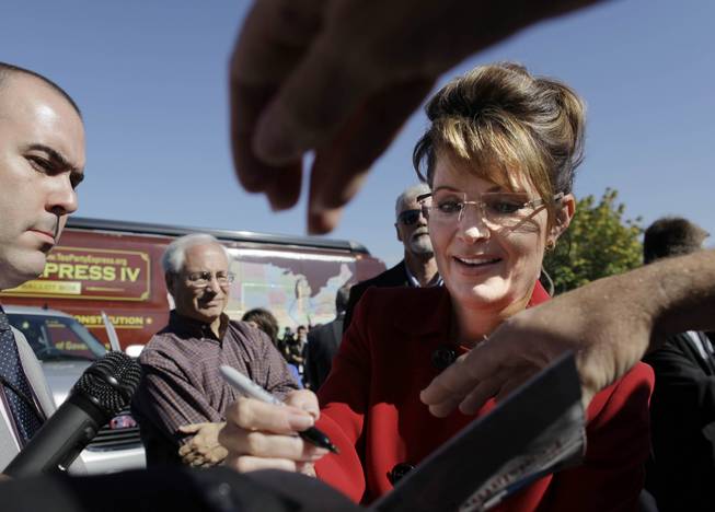 Sarah Palin signs her autograph for supporters after a rally to kick off the Tea Party Express bus tour Monday, Oct. 18, 2010, in Reno. Ahead of Saturday's Nevada caucuses, Palin this week reiterated her call for Republican voters to back Newt Gingrich's candidacy in an effort to extend the selection process for the GOP presidential nomination.
