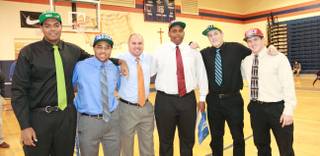 Bishop Gorman High football players, from left, Ronnie Stanley (Notre Dame), Shaquille Powell (Duke), coach Tony Sanchez, Ron Scoggins Jr. (UNLV), Zach Hutchins (Montana State) and Marc Philippi (UNLV) pose for a photo on national signing day.