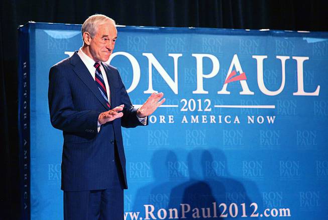 Republican presidential candidate U.S. Rep. Ron Paul, R-Texas, gestures for the audience to settle down after taking the stage during a campaign event at the Four Seasons Las Vegas on Wednesday, Feb. 1, 2012.