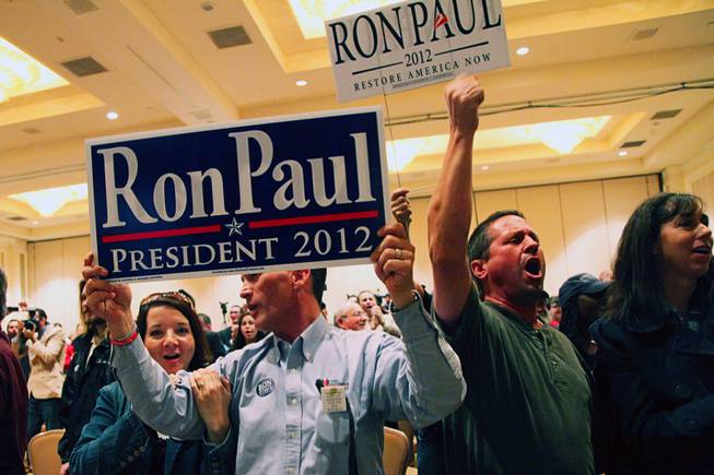 Supporters cheer for Republican presidential candidate U.S. Rep Ron Paul (R-TX) speaks during a campaign event at the Four Seasons Las Vegas Wednesday, February 1, 2012.