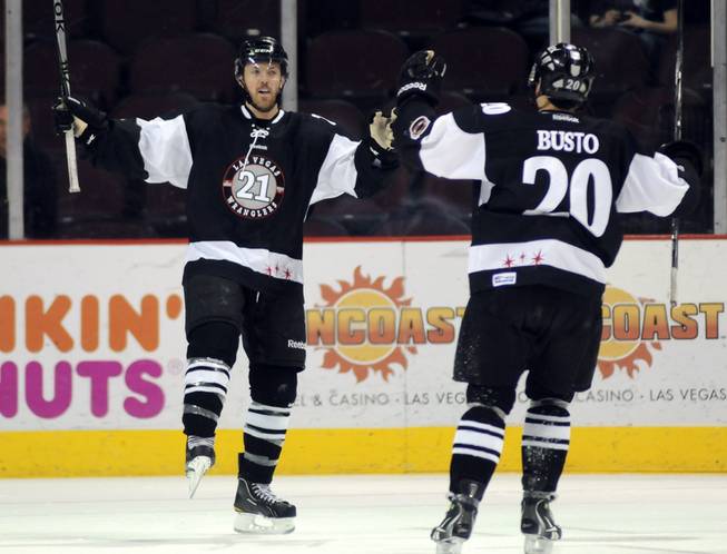 Josh Lunden, (21) celebrates with teammate Michael Busto, right, after scoring a first period goal against the Alaska Aces on Thursday night.