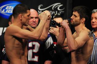 Nick Diaz and Carlos Condit face off during the weigh in for UFC 143 Friday, Feb. 3, 2012 at Mandalay Bay.