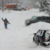 A man walks through the snow, Friday, Feb. 3, 2012, in Denver. A powerful winter storm swept across Colorado today as it headed east, bringing blizzard warnings to eastern Colorado and winter storm warnings for southeast Wyoming, western Kansas and western Nebraska. 