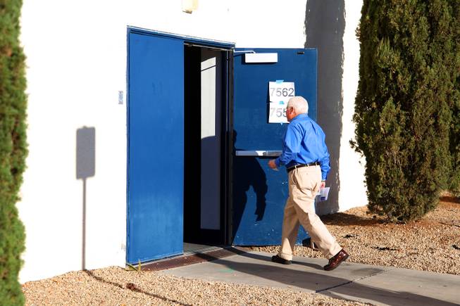 A man walks into the auditorium at Boulder City High School during the Republican caucus in Boulder City on Saturday, Feb. 4, 2012.