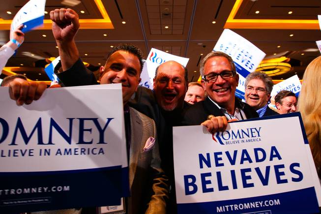 From left, friends Mick Cacucciolo, Chris Leggio and Mitch Cummins cheer and chant "Mitt" during the Nevada Republican caucus Saturday, Feb. 4, 2012, at the Red Rock Hotel and Casino in Las Vegas.