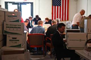 Volunteers count and record caucus totals at Clark County GOP headquarters Sunday morning.