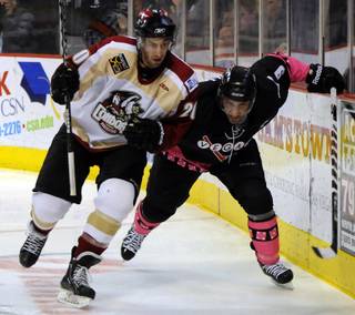 Defensemen Alain Goulet, left and Mike Madill battle for position along the boards behind the Condors net as Las Vegas hosted Bakersfield on Friday night at the Orleans Arena.