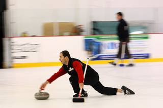 Curling instructor Nick Kitinski shows his curling form as he releases a stone during an open practice session of the Las Vegas Curling Club at the Las Vegas Ice Center on West Flamingo Road on Feb 12, 2012.