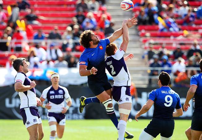 France's Jean Bapiste Mazoue, left, and Scotland's Michael Fedo jump for the ball during the USA Sevens Rugby tournament at Sam Boyd Stadium on Sunday, Feb. 12, 2012. France beat Scotland 22-7 to win the Shield Final.